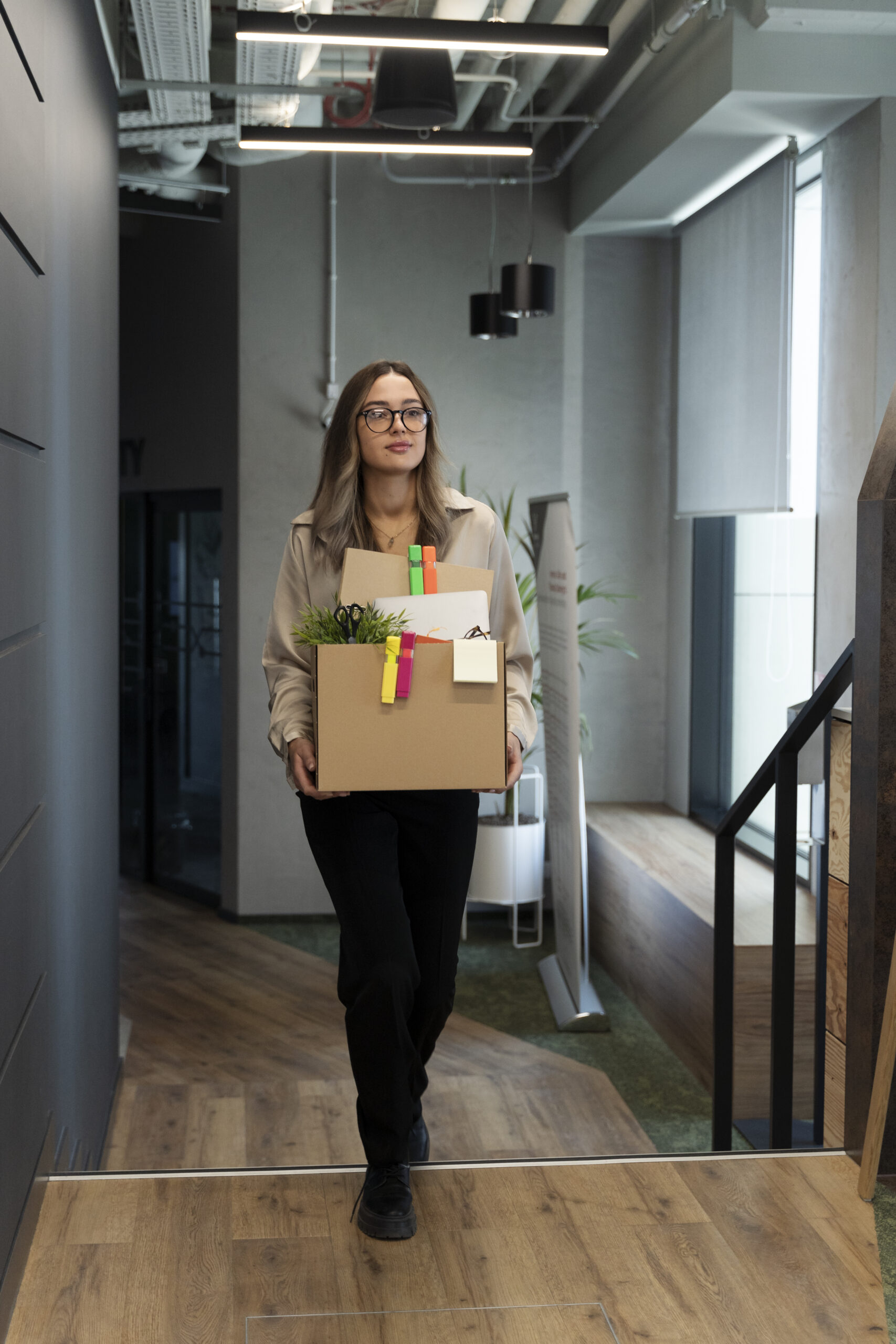 Full shot woman holding cardboard box